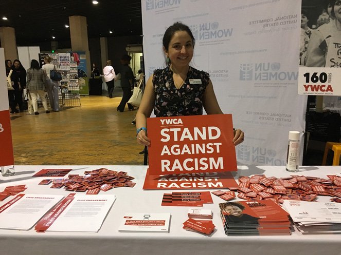 Woman volunteering at the YWCA table